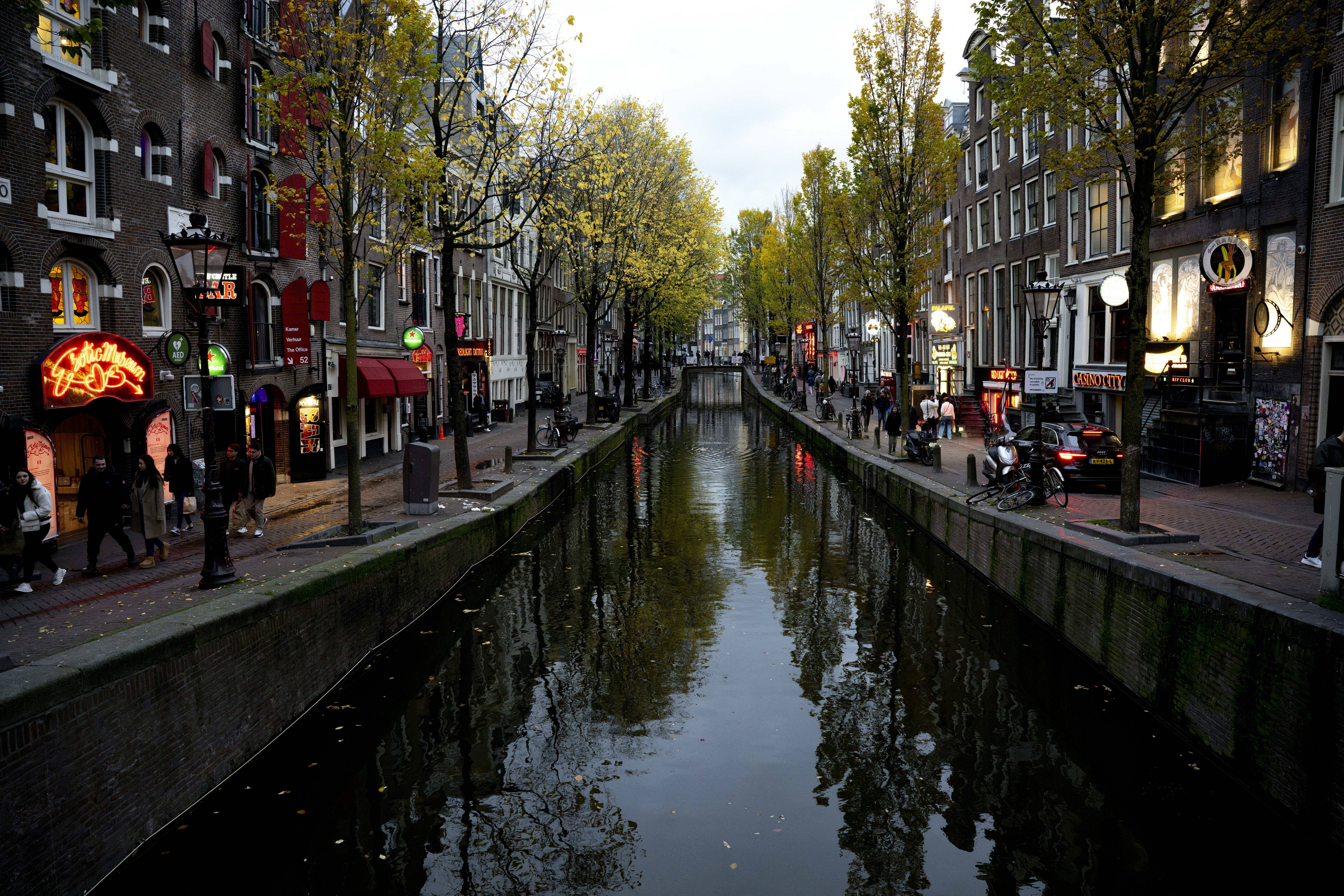 This photograph shows the Oudezijds Achterburgwal, in Amsterdam, on November 15, 2024. By a canal in Amsterdam's red light district, one of the so-called window women is actually a hologram of murdered sex worker Bernadette Szabo, known as Betty, Dutch police hope will help solve her horrific murder dating back to 2009. (Photo by Nick Gammon / AFP)
