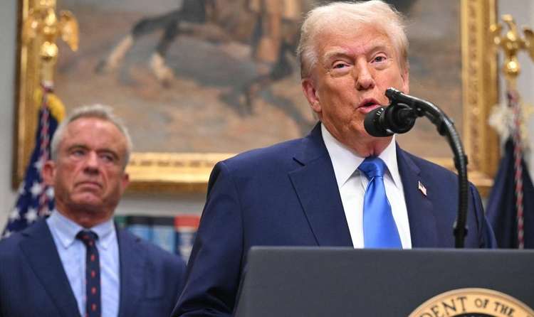 US President Donald Trump (R), alongside Secretary of Health and Human Services Robert F. Kennedy Jr. (L), speaks about autism in the Roosevelt Room of the White House in Washington, DC on September 22, 2025. (Photo by SAUL LOEB / AFP)